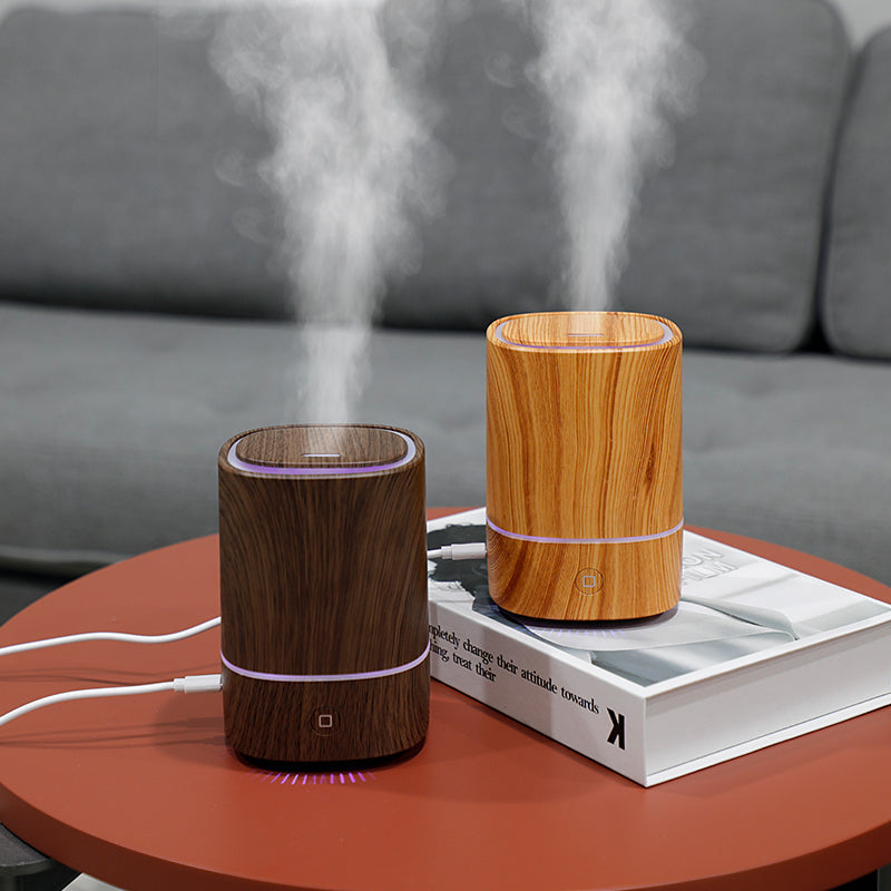 Sand and Ember wood grain aroma diffusers releasing mist
